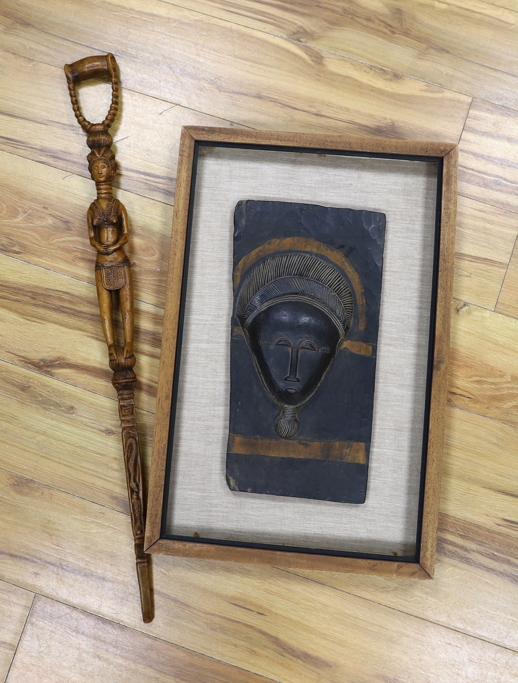 An African framed tribal mask and a carved stick